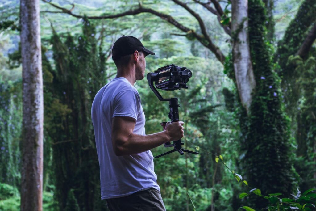 a man holding camera in woods showing transformation from old to modern video 