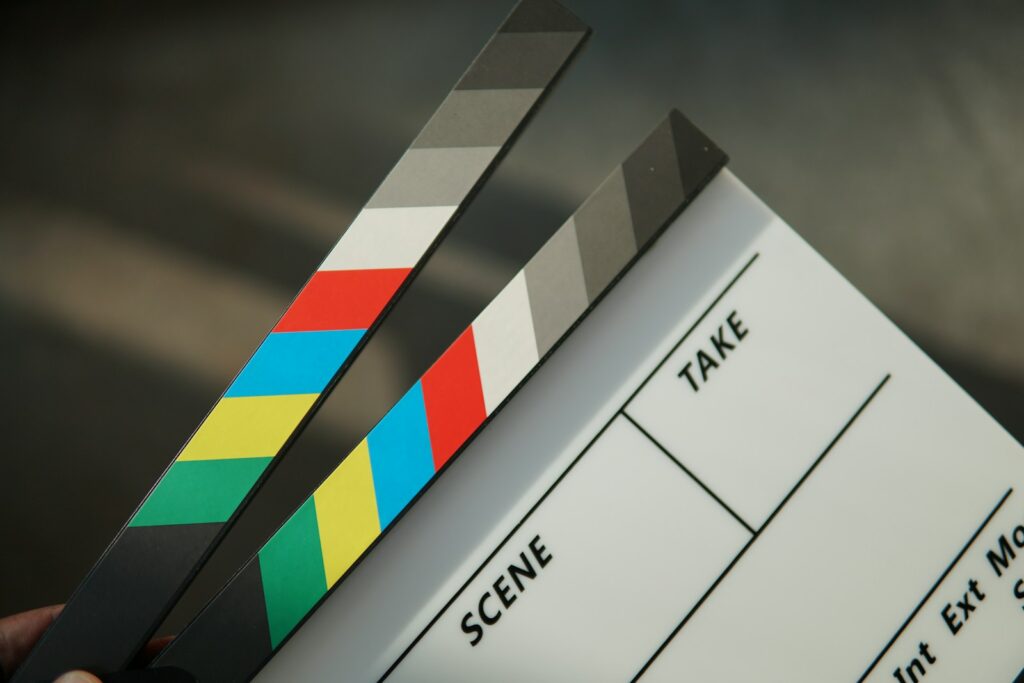 A person holding a clapstick in their hand showing challenges for Video generation 